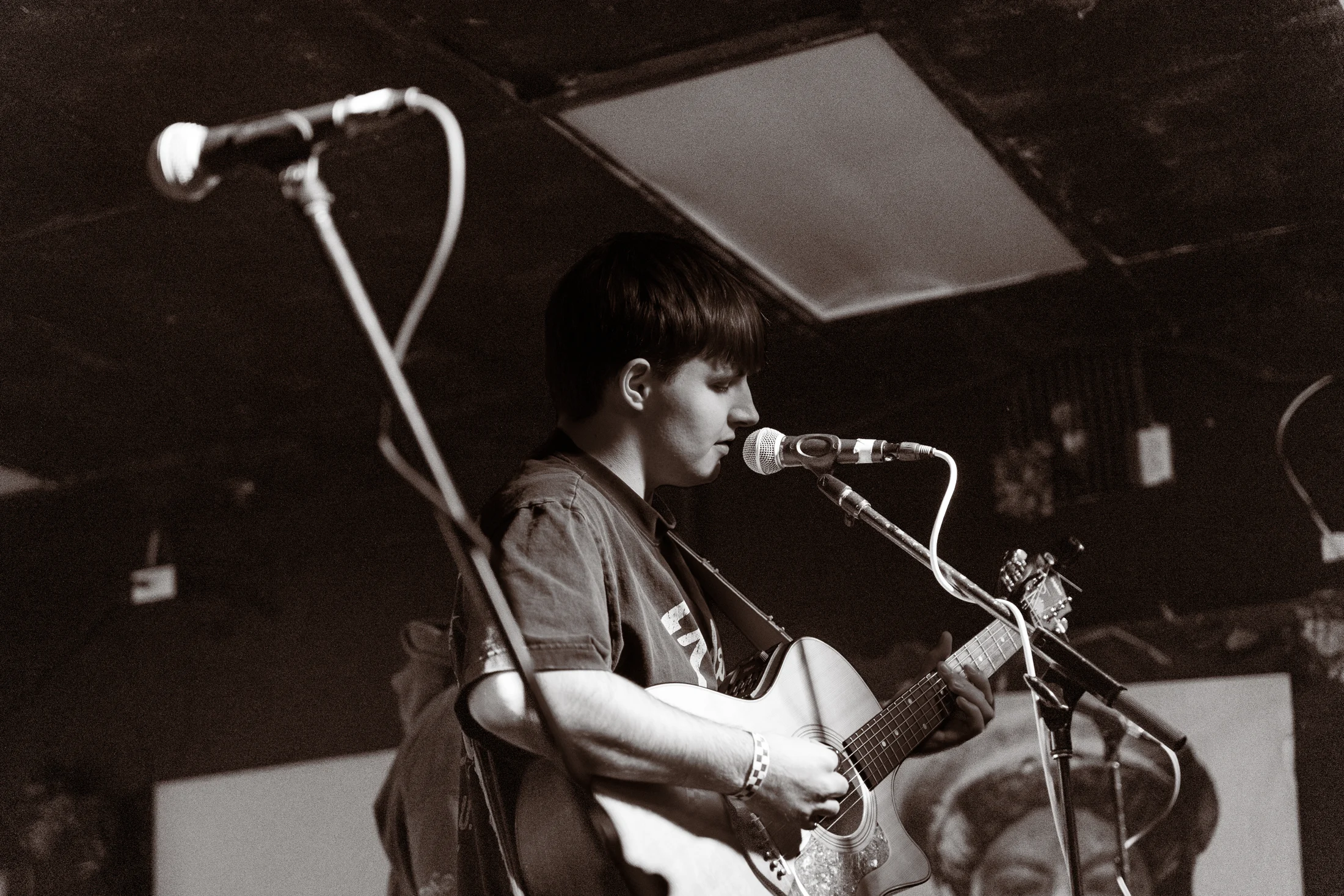 Hollowstem vocalist playing acoustic guitar on stage