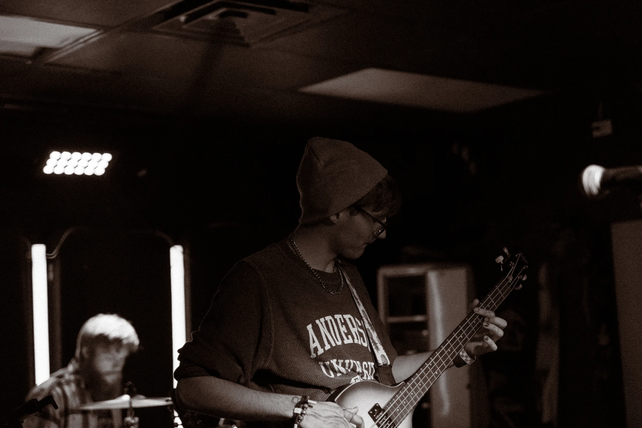 Hollowstem bassist under the stage lights